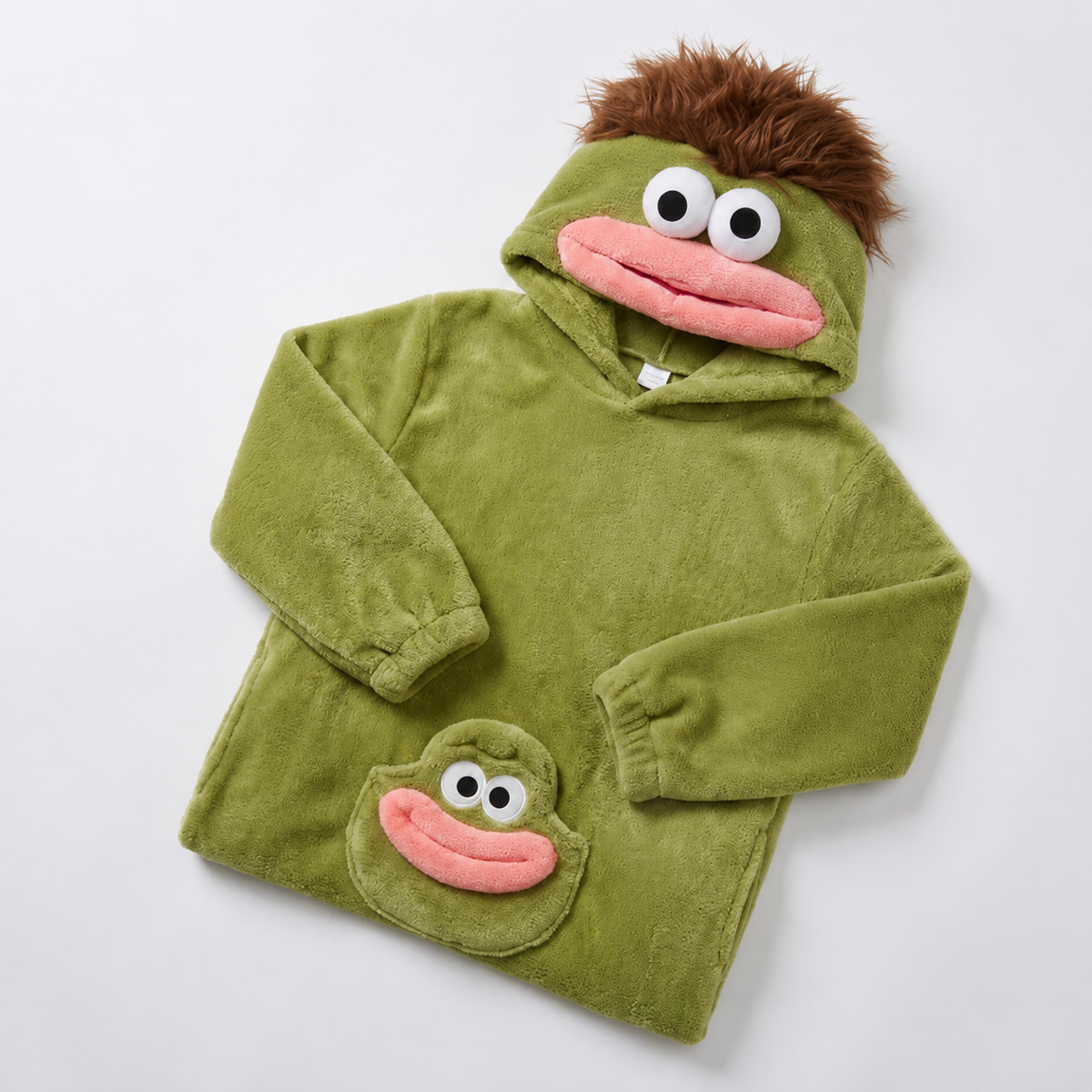 Green plush monster onesie folded with brown tuft and pink mouth hood