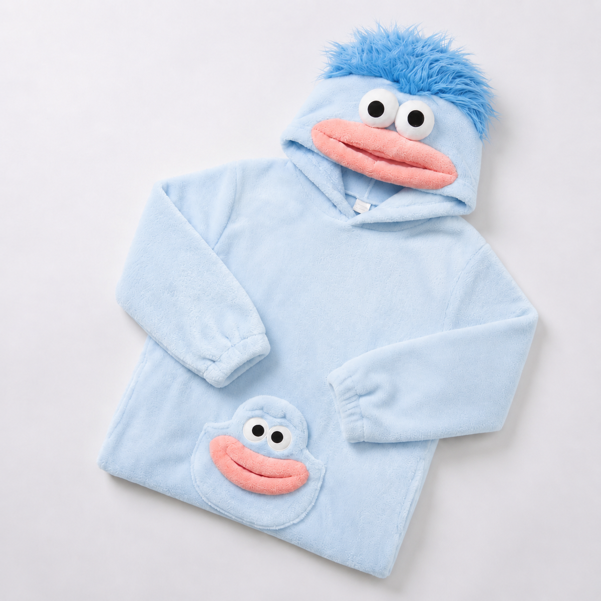 Light blue plush monster onesie folded with pink mouth hood